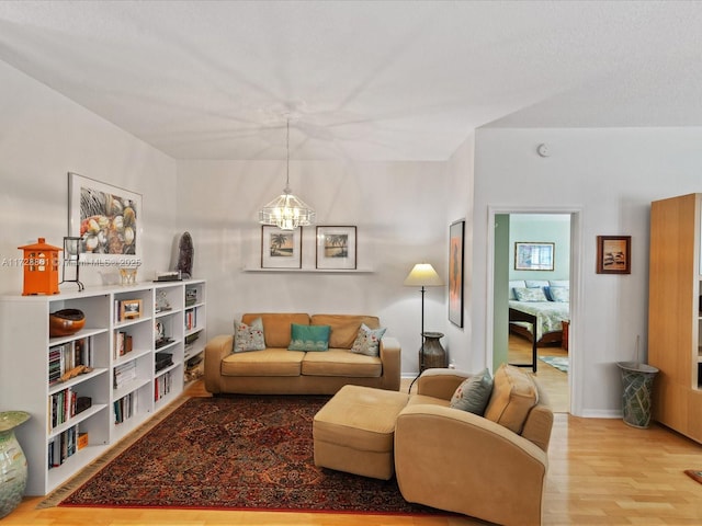 living room featuring hardwood / wood-style flooring and a chandelier