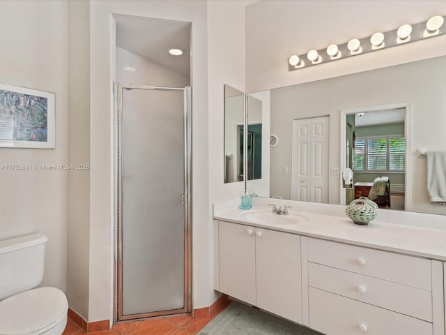 bathroom featuring vanity, toilet, tile patterned floors, and a shower with shower door