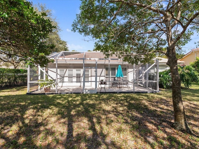 back of house featuring a lanai, a lawn, and a patio area