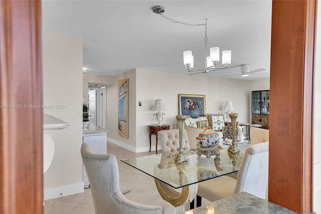 tiled dining room with an inviting chandelier