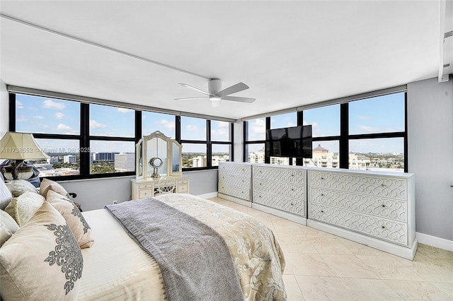 bedroom with multiple windows, light tile patterned flooring, and ceiling fan