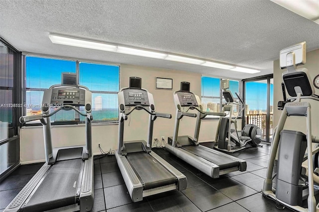 workout area with plenty of natural light and a textured ceiling