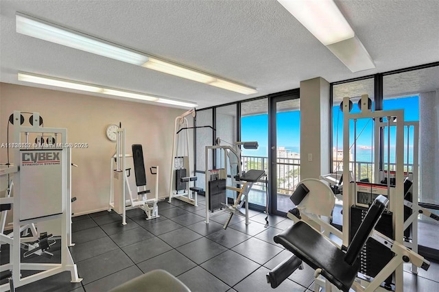 gym featuring a textured ceiling and expansive windows