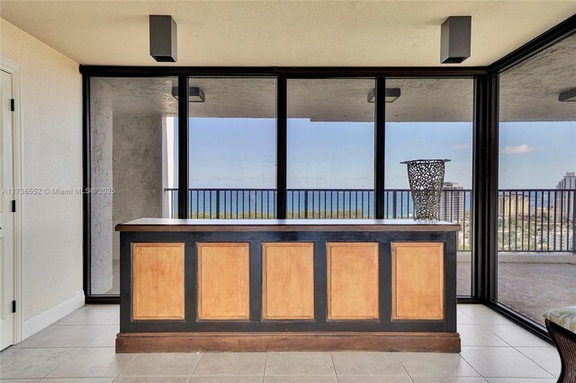 view of patio / terrace with a balcony and a water view