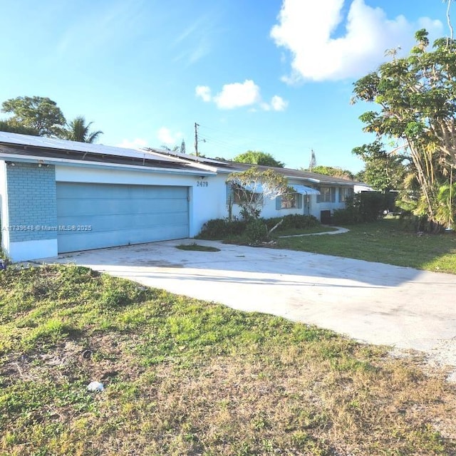 single story home with a garage and a front yard