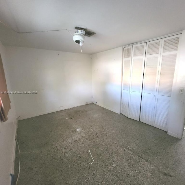 unfurnished bedroom with a closet and ceiling fan