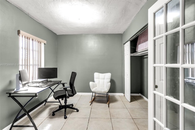 home office featuring light tile patterned floors and a textured ceiling