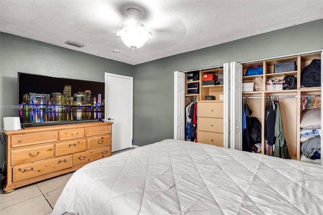 tiled bedroom with multiple closets