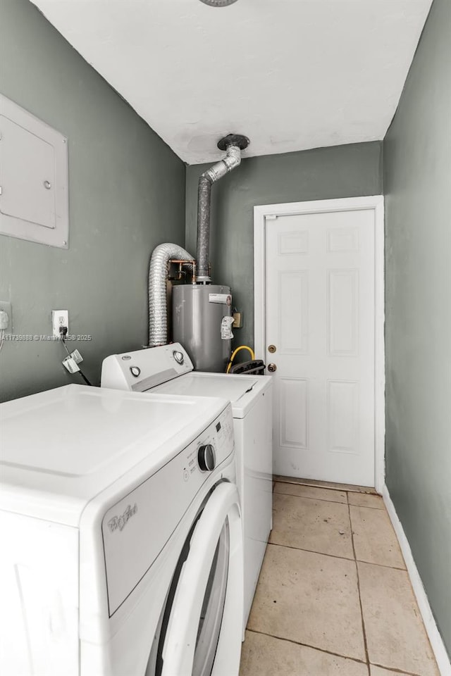 clothes washing area with water heater, light tile patterned floors, and washer and clothes dryer