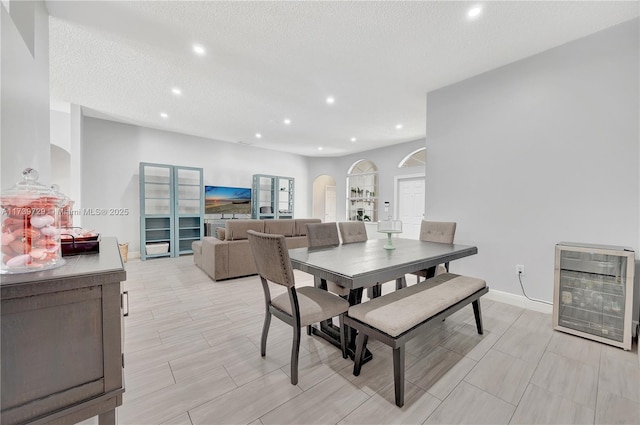 dining area with heating unit and a textured ceiling