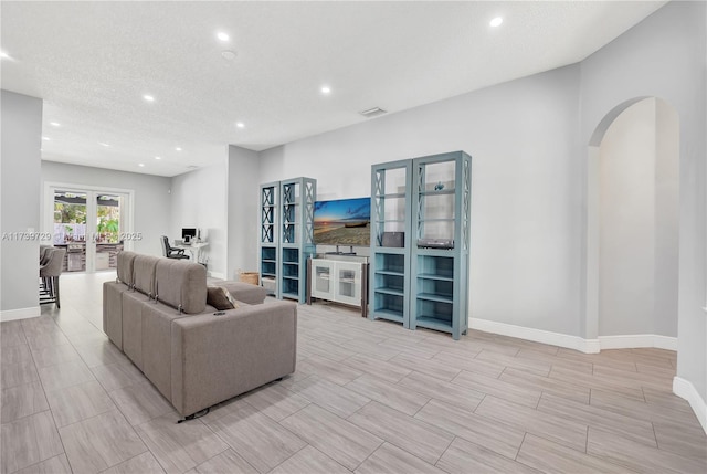 living room with a textured ceiling