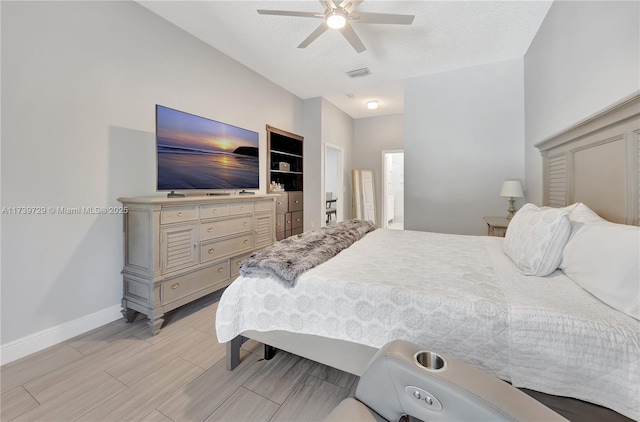 bedroom with ceiling fan and a textured ceiling