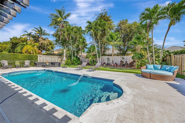 view of swimming pool featuring pool water feature, an outdoor living space, and a patio