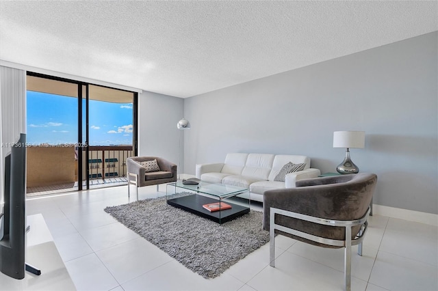 tiled living room with expansive windows and a textured ceiling