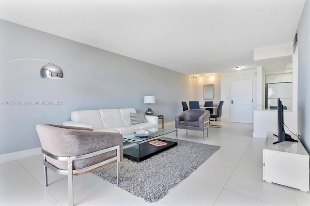 tiled living room featuring a textured ceiling