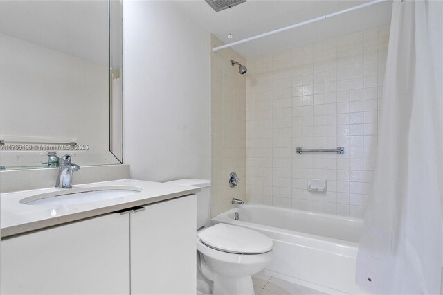 full bathroom with shower / tub combo, vanity, tile patterned floors, and toilet