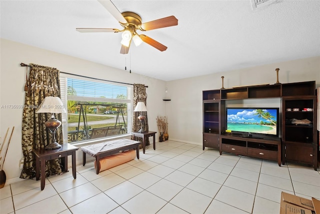 living area featuring light tile patterned floors and ceiling fan