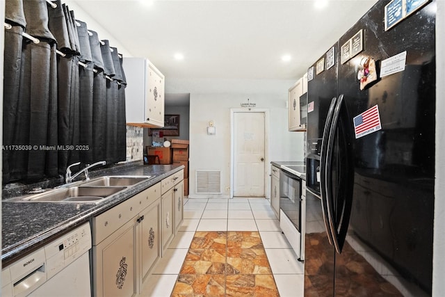 kitchen with electric stove, a sink, white dishwasher, black refrigerator with ice dispenser, and visible vents
