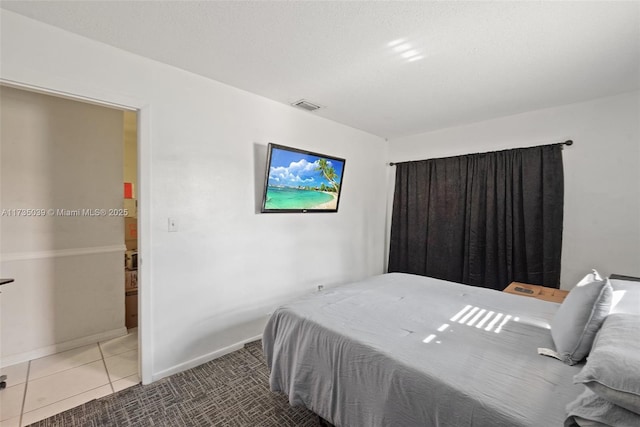 tiled bedroom featuring visible vents and baseboards