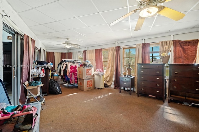 interior space with a drop ceiling and ceiling fan