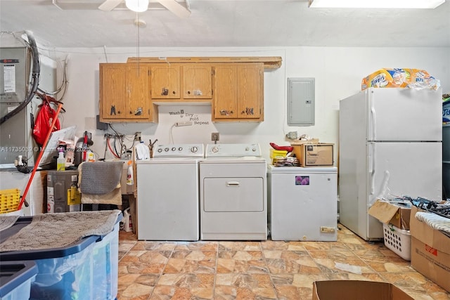 laundry area featuring stone finish floor, washing machine and dryer, ceiling fan, electric panel, and cabinet space