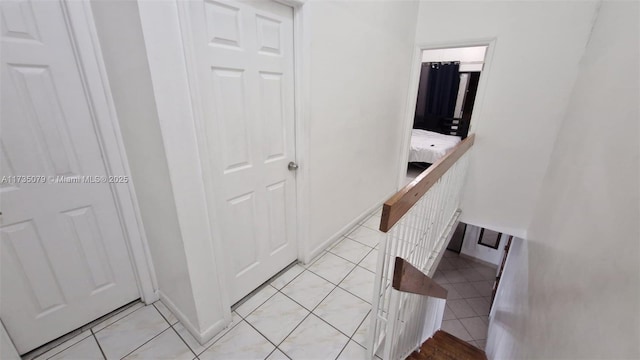 hall featuring light tile patterned flooring