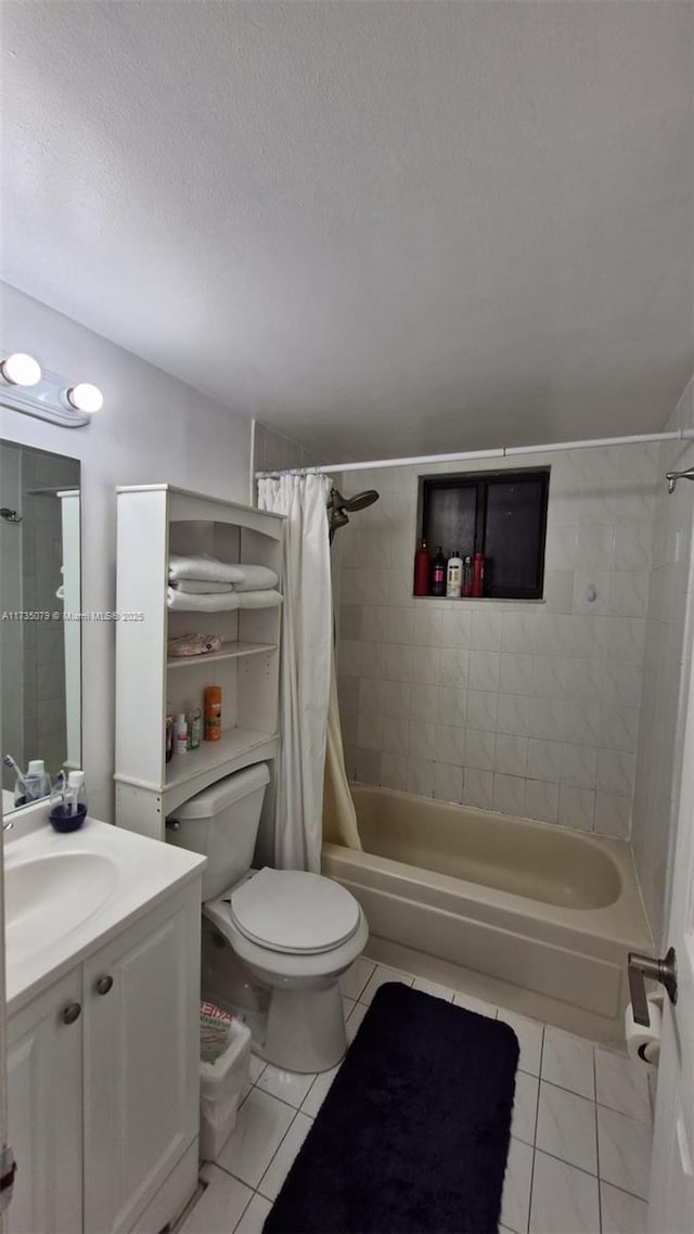 full bathroom featuring tile patterned flooring, vanity, shower / tub combo, toilet, and a textured ceiling