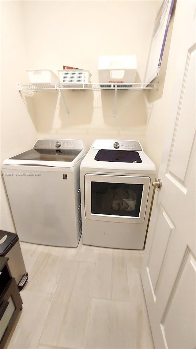 washroom featuring laundry area and washer and clothes dryer