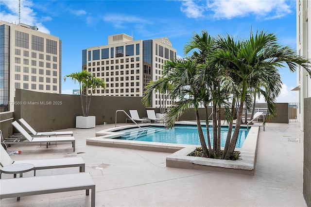 pool featuring a patio area and fence