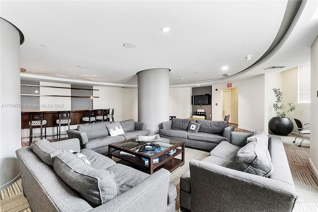 living area featuring visible vents and recessed lighting