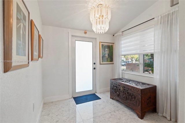 doorway with a chandelier, light tile patterned flooring, vaulted ceiling, and baseboards