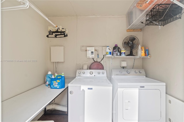 clothes washing area featuring laundry area and washer and clothes dryer