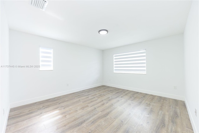 empty room with light hardwood / wood-style flooring