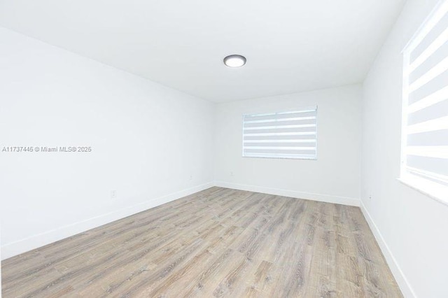 unfurnished room with light wood-type flooring