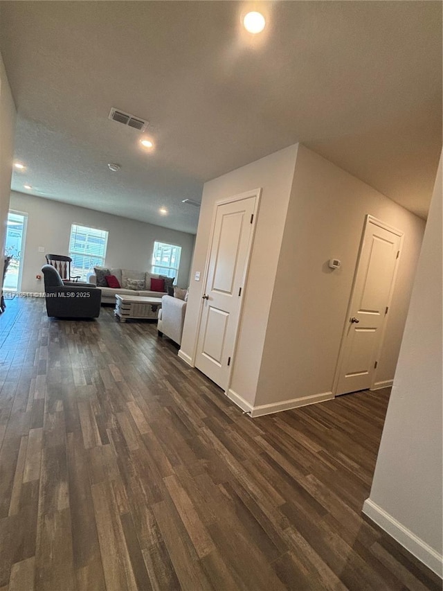 corridor with dark hardwood / wood-style floors