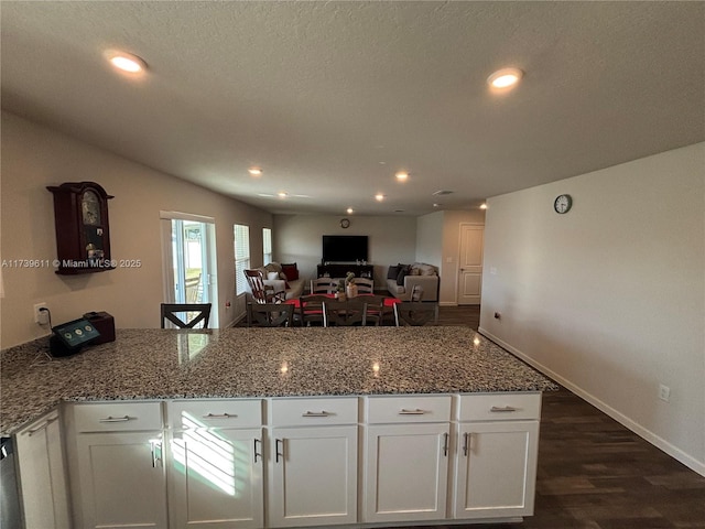 kitchen featuring dishwasher, white cabinetry, stone countertops, and dark hardwood / wood-style floors