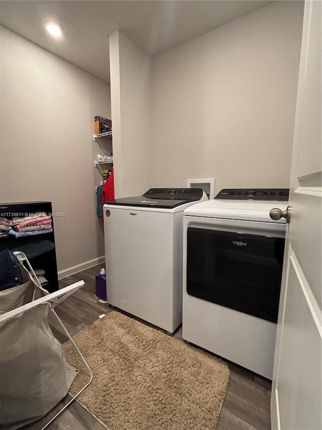 clothes washing area featuring separate washer and dryer and dark hardwood / wood-style floors