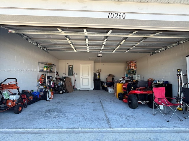 garage with a garage door opener and electric panel