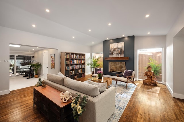 living room with vaulted ceiling and hardwood / wood-style floors