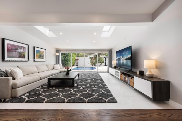 living room featuring vaulted ceiling with skylight