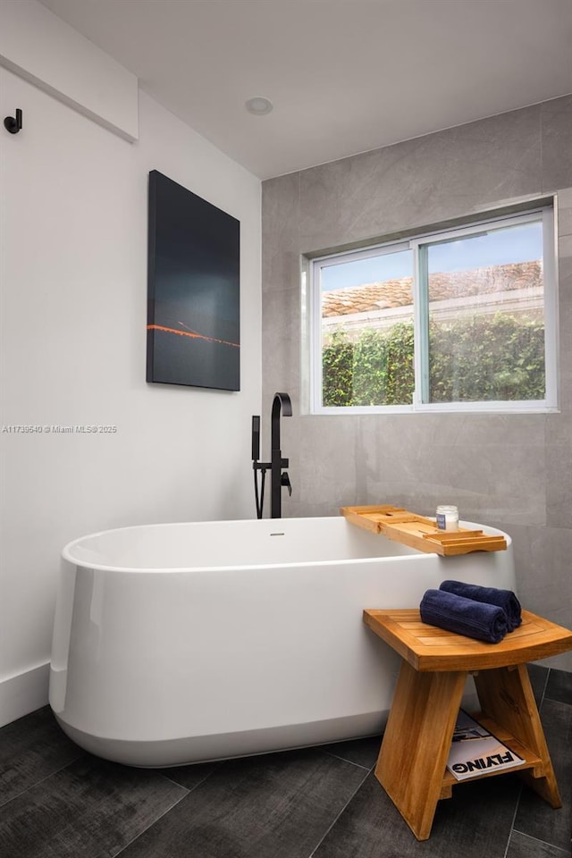 bathroom with a tub to relax in