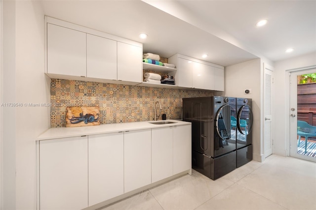 laundry area with sink, cabinets, and washer and dryer