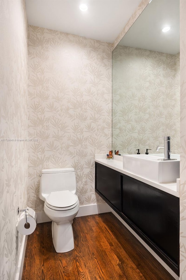 bathroom with vanity, hardwood / wood-style floors, and toilet