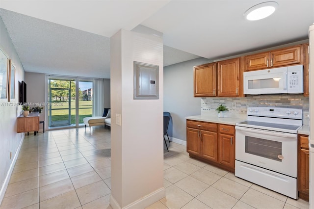 kitchen featuring light tile patterned floors, electric panel, white appliances, and decorative backsplash