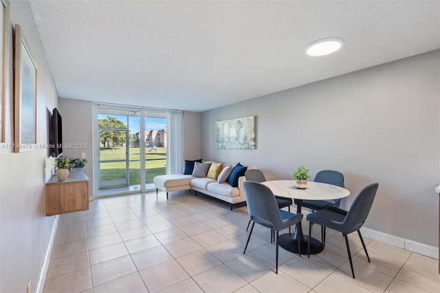 tiled dining area with a wall of windows and a textured ceiling