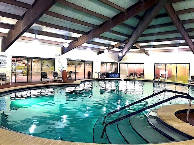 view of swimming pool featuring a hot tub