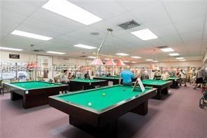 rec room with a paneled ceiling