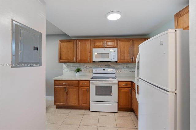 kitchen featuring light tile patterned flooring, white appliances, electric panel, and tasteful backsplash