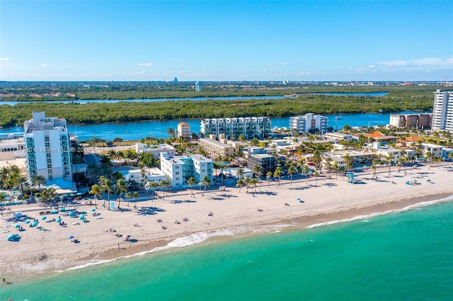 birds eye view of property with a water view and a view of the beach