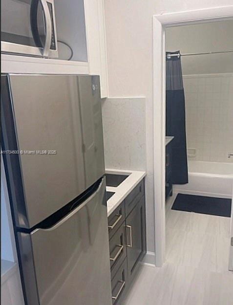 bathroom with vanity and shower / bathtub combination with curtain